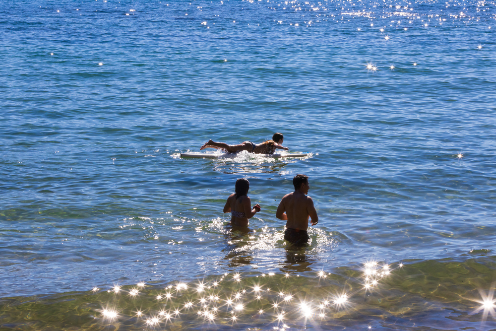 Lake,Tahoe,,Nevada,,Usa,-,Aug,12,2019:,People,Swimming,And Featured image showing a family cooling off in the pristine waters of Lake Tahoe in the summer.